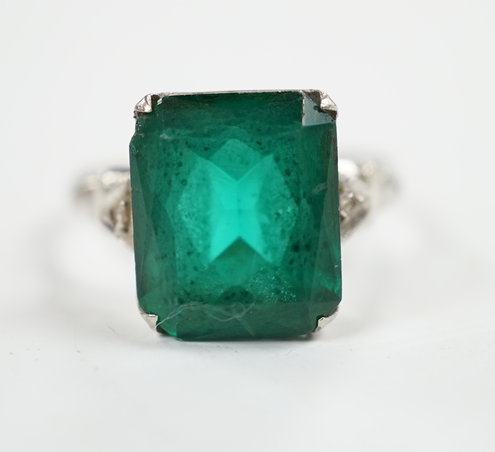 A 14k and single stone green paste set ring, with diamond chip set shoulders, size P, gross weight 3.5 grams.